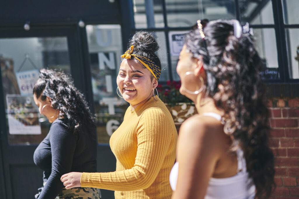 Three women enjoying a sunny day in the city