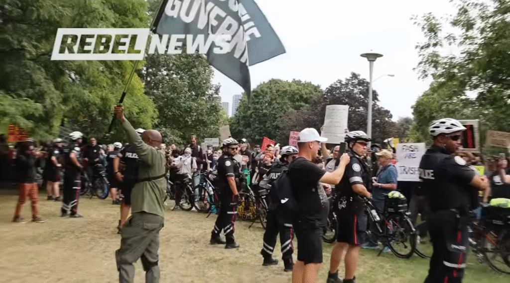 Rebel News Protest to Punch-up flag guy